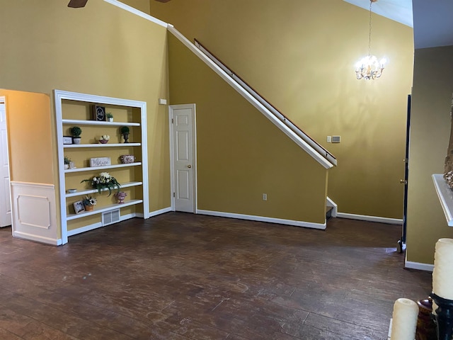 unfurnished living room featuring a notable chandelier, high vaulted ceiling, and dark hardwood / wood-style flooring