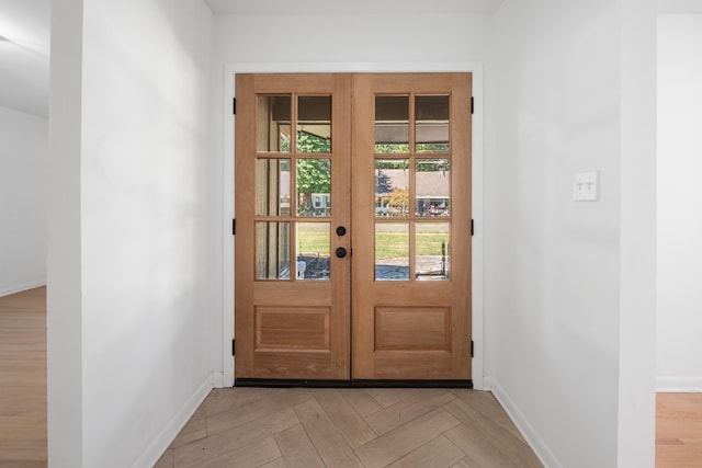 doorway to outside with french doors and light parquet floors