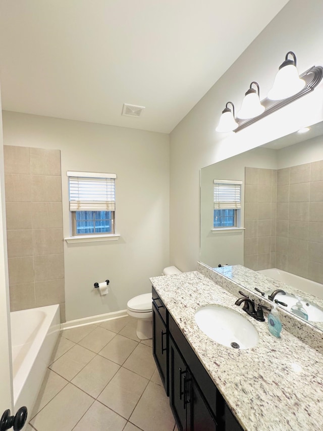 bathroom with tile patterned flooring, vanity, and toilet