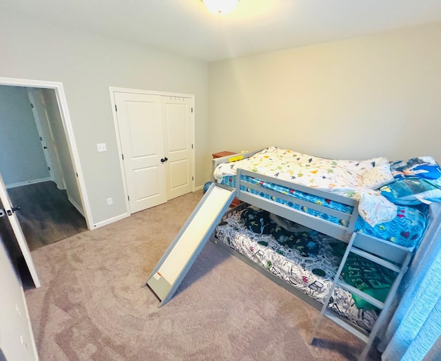 bedroom with carpet flooring and a closet