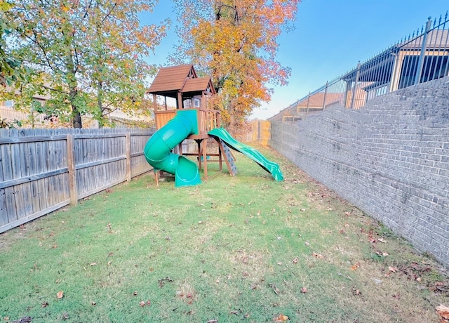 view of playground with a lawn