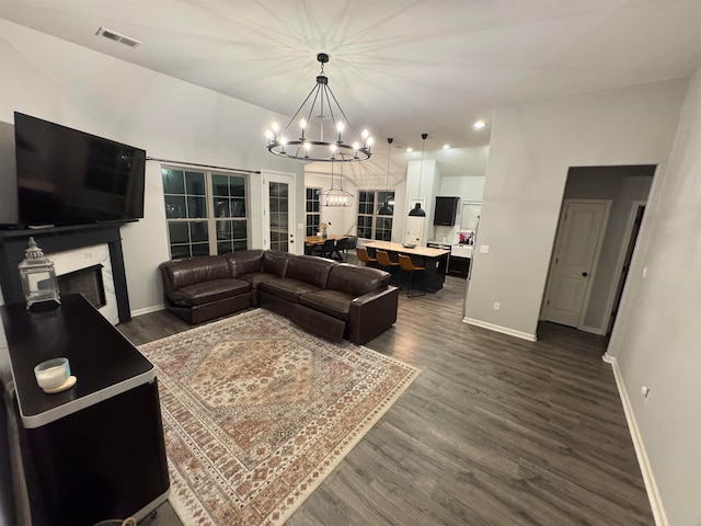 living room featuring dark hardwood / wood-style floors and a chandelier