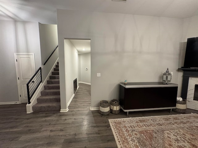 interior space featuring a fireplace and dark wood-type flooring