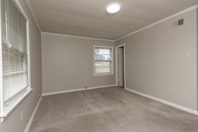 empty room with light carpet, ornamental molding, and a textured ceiling
