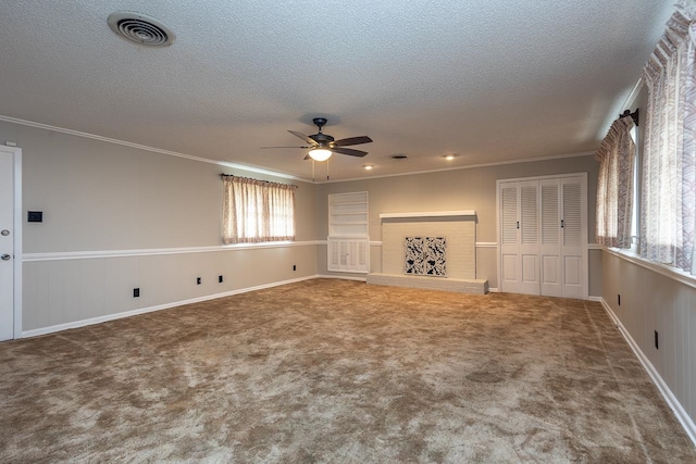 unfurnished living room featuring ornamental molding, carpet flooring, and ceiling fan