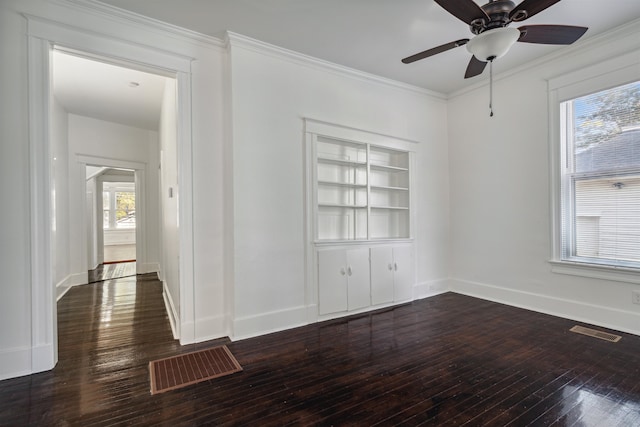 unfurnished room featuring dark wood-type flooring, crown molding, a healthy amount of sunlight, and ceiling fan