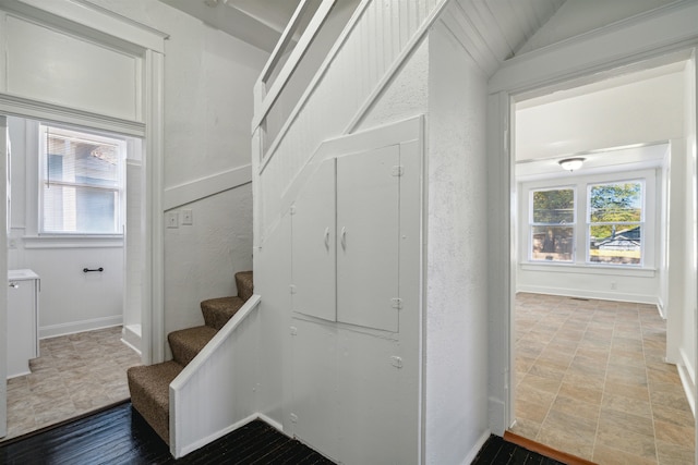 staircase with lofted ceiling