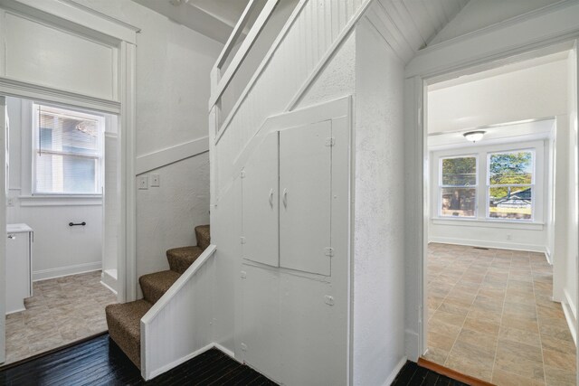 2186 Monroe Ave, Memphis, TN 38104 - stairs with healthy amount of natural light, baseboards, and stone finish flooring