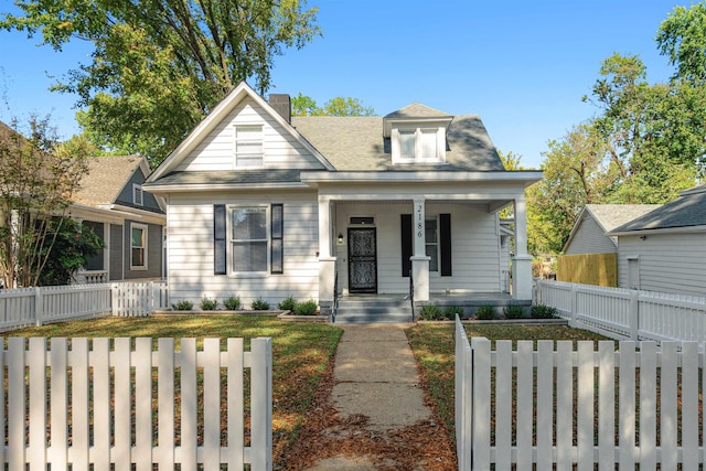 2186 Monroe Ave, Memphis, TN 38104 - bungalow-style house featuring covered porch and a fenced front yard