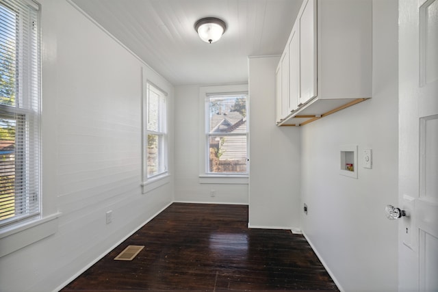 clothes washing area featuring washer hookup, cabinets, and dark hardwood / wood-style floors