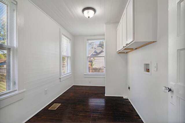 2186 Monroe Ave, Memphis, TN 38104 - washroom featuring cabinet space, dark wood-type flooring, hookup for a washing machine, baseboards, and electric dryer hookup