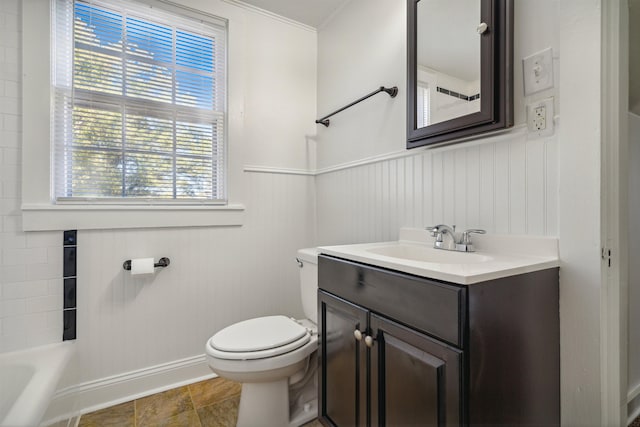 2186 Monroe Ave, Memphis, TN 38104 - bathroom with toilet, vanity, baseboards, a bathtub, and a wainscoted wall