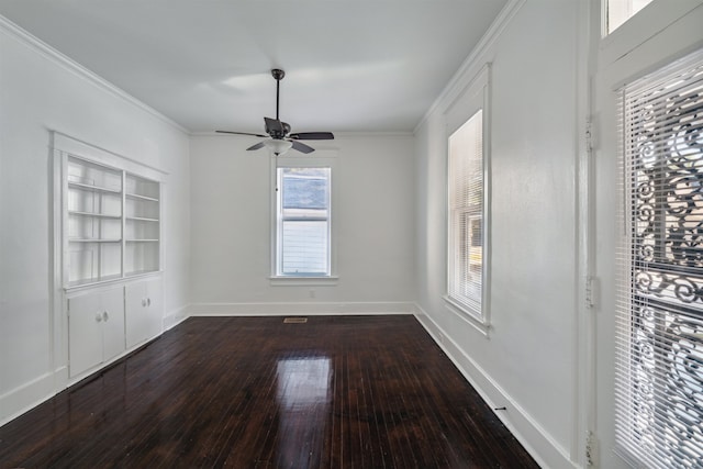 unfurnished room featuring crown molding, hardwood / wood-style flooring, built in shelves, and ceiling fan