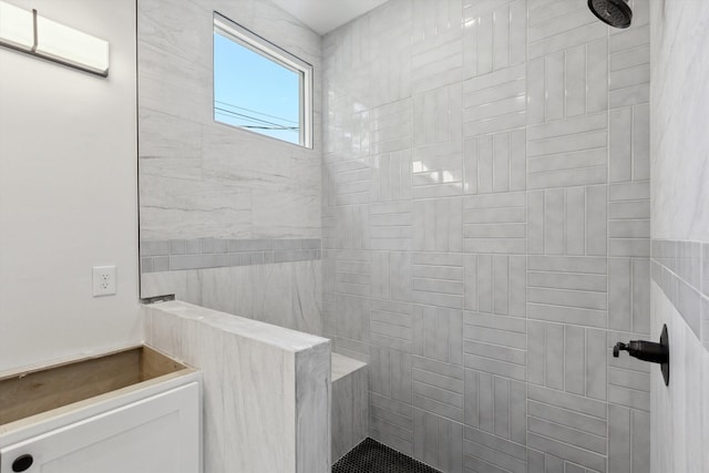 bathroom with a tile shower