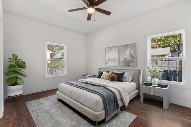 bedroom featuring baseboards, a ceiling fan, and wood finished floors