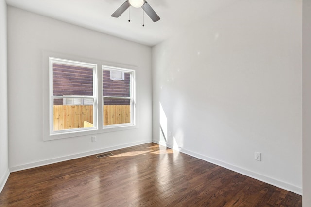 unfurnished room featuring visible vents, wood finished floors, baseboards, and ceiling fan