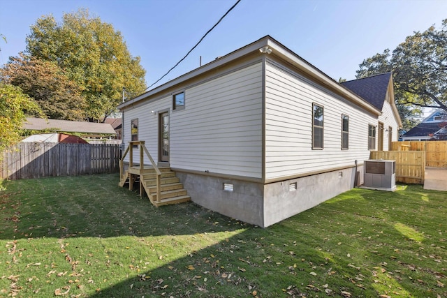 view of home's exterior featuring a lawn, cooling unit, a fenced backyard, and crawl space