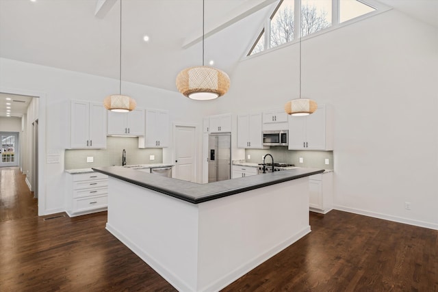 kitchen featuring stainless steel appliances, white cabinetry, high vaulted ceiling, and backsplash