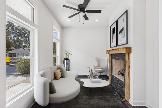 sitting room featuring a fireplace, ceiling fan, baseboards, and recessed lighting