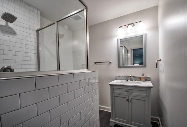 bathroom featuring vanity, a shower with shower door, and tile patterned floors