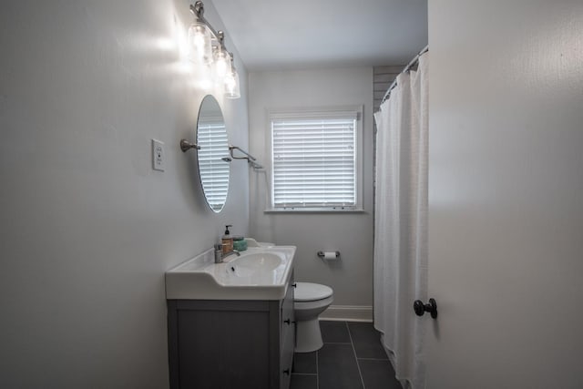 bathroom with toilet, vanity, and tile patterned flooring