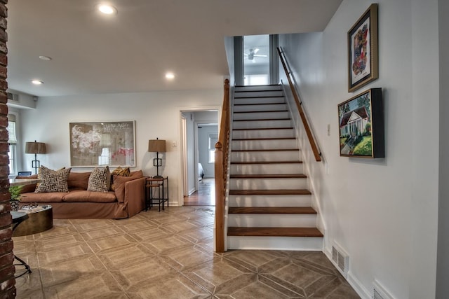 staircase featuring plenty of natural light