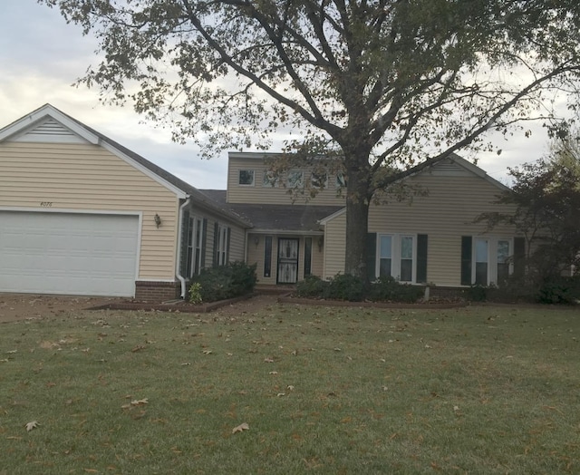 view of front of home featuring a garage and a front lawn