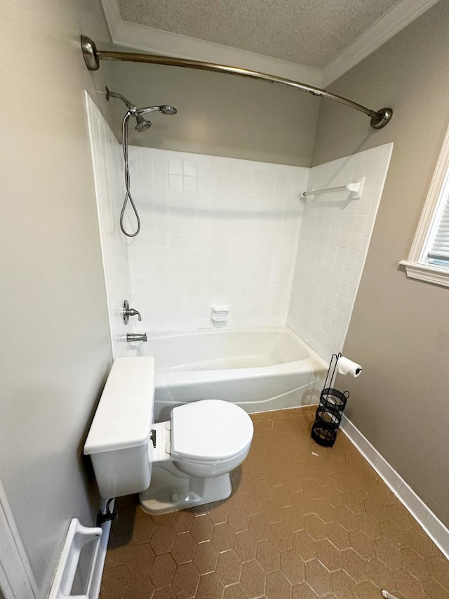 bathroom featuring tile patterned floors, toilet, ornamental molding,  shower combination, and a textured ceiling