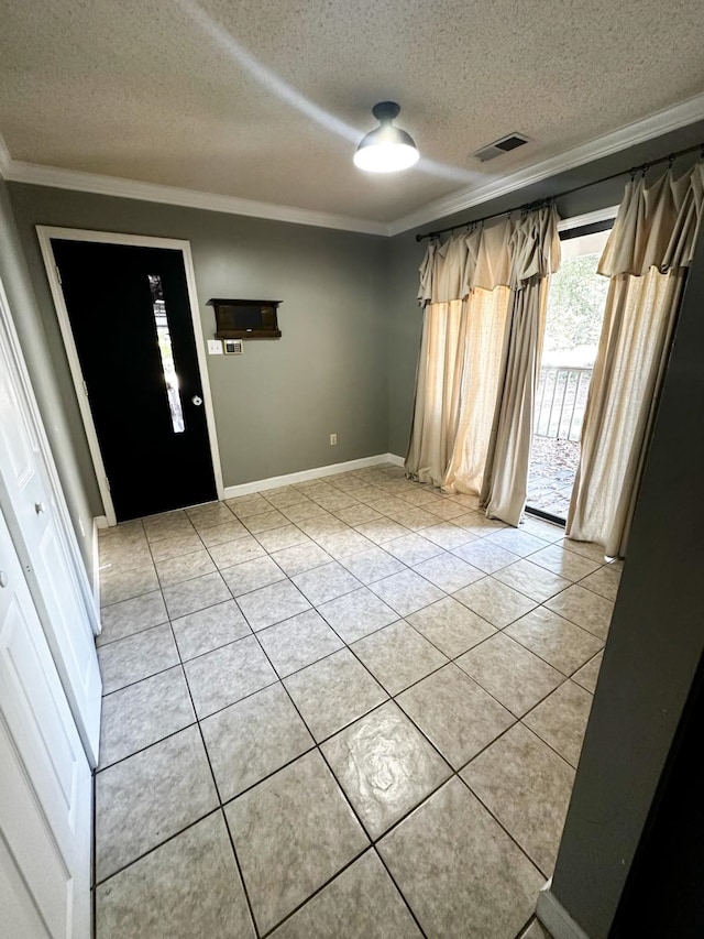 entrance foyer featuring crown molding, a textured ceiling, and light tile patterned flooring