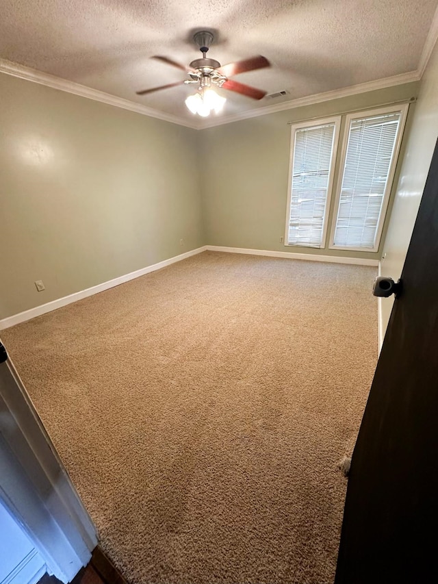 carpeted empty room with crown molding, a textured ceiling, and ceiling fan