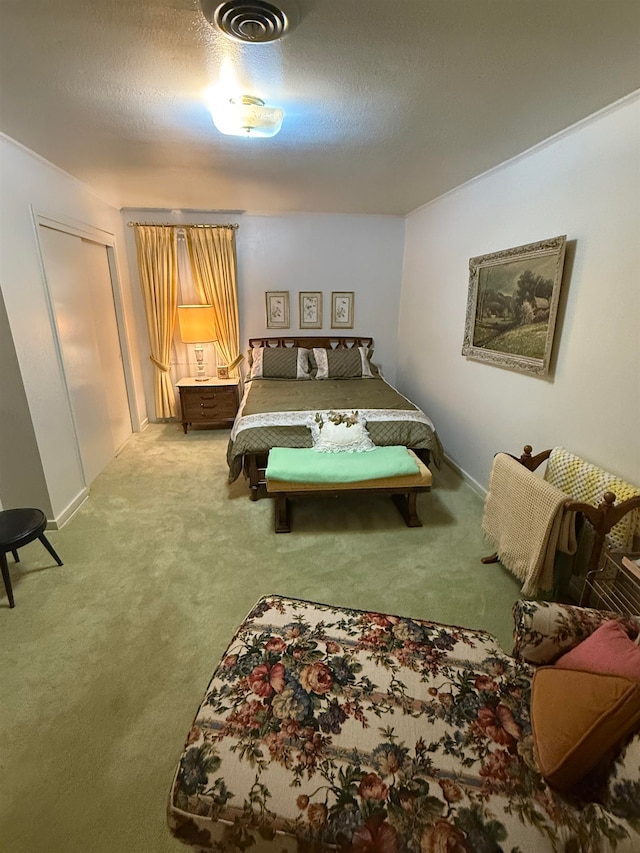 bedroom featuring carpet flooring and a textured ceiling