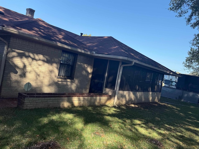 rear view of house featuring a yard