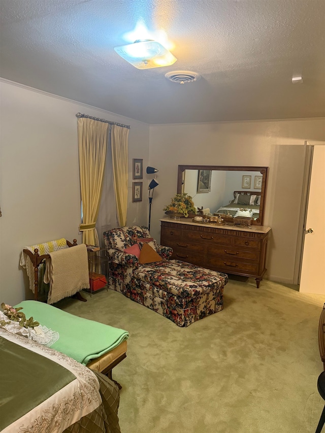 bedroom featuring light carpet and a textured ceiling