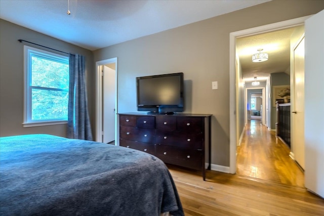 bedroom featuring a textured ceiling and light wood-type flooring