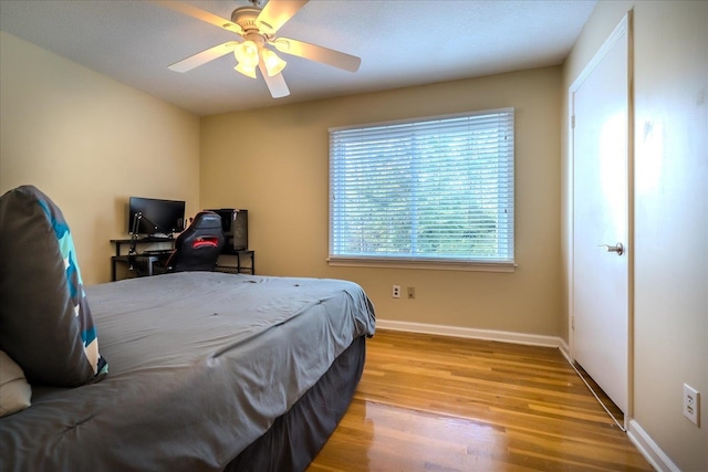 bedroom featuring light hardwood / wood-style floors and ceiling fan