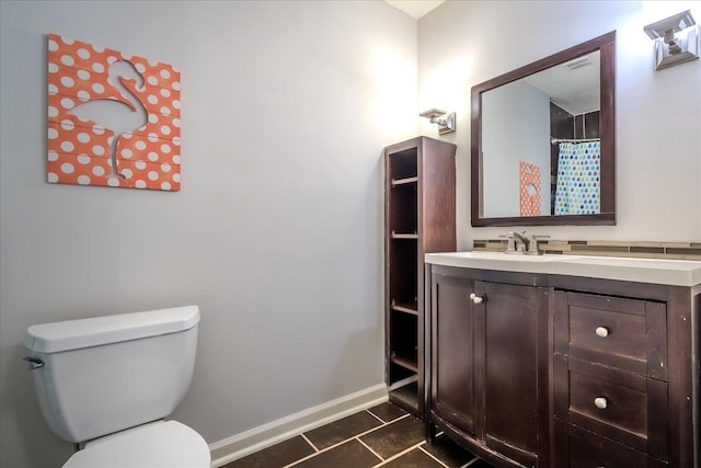 bathroom featuring vanity, a shower with curtain, toilet, and tile patterned floors