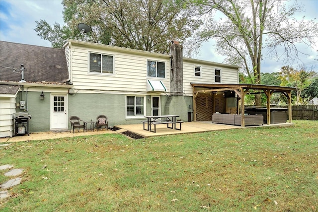 back of property with a patio area, an outdoor living space, and a yard