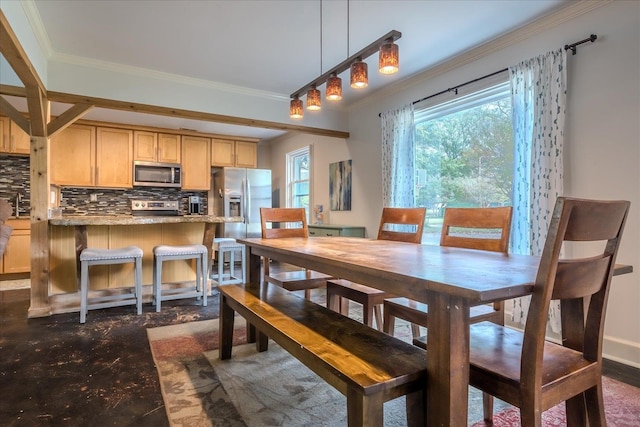 dining space with ornamental molding