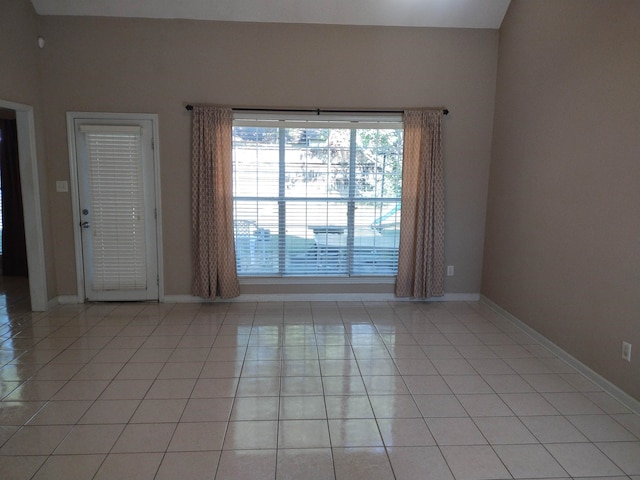 unfurnished room with light tile patterned flooring