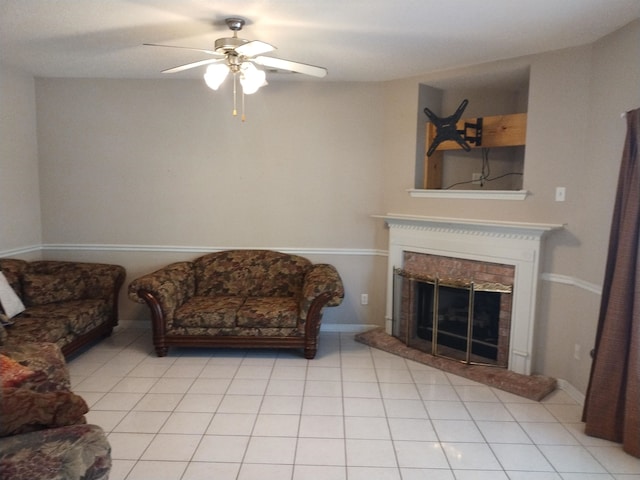 living room with a fireplace, light tile patterned floors, and ceiling fan