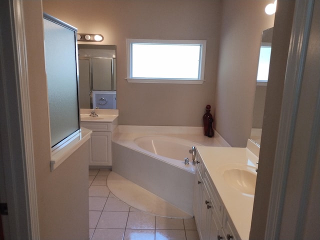 bathroom featuring tile patterned floors, vanity, and plus walk in shower