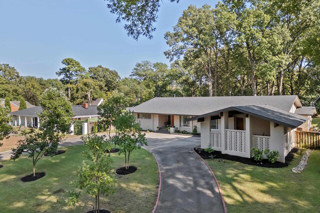 ranch-style house with a front lawn and a porch