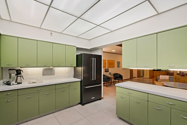 kitchen featuring high end refrigerator and light tile patterned flooring