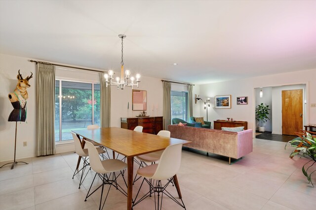 tiled dining space featuring a chandelier