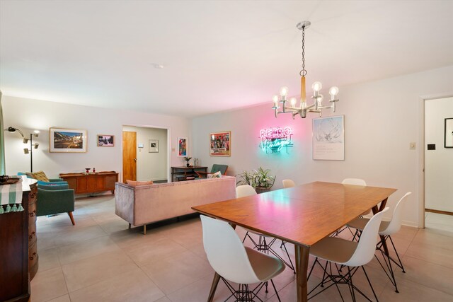 dining space with a chandelier and light tile patterned floors