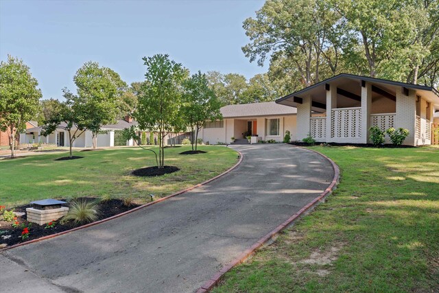 view of front of home with a garage and a front lawn