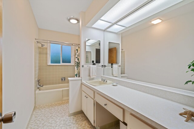 bathroom with shower / bath combo, vanity, and a skylight