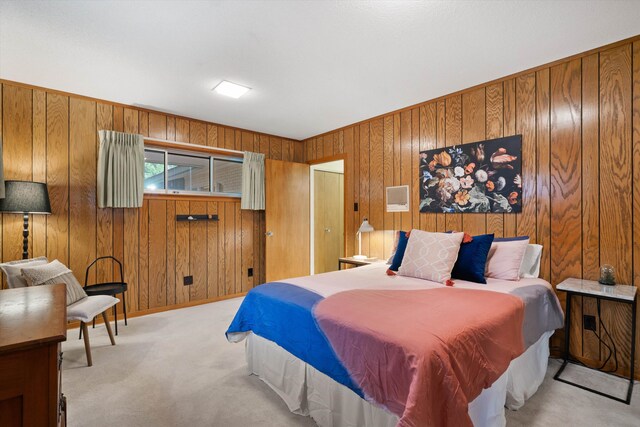 carpeted bedroom with wooden walls