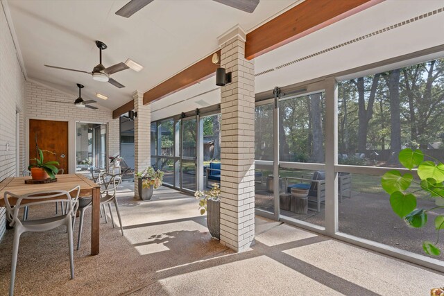 sunroom featuring ceiling fan and vaulted ceiling