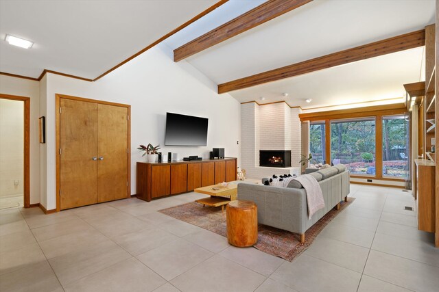 living room with a brick fireplace, light tile patterned flooring, and lofted ceiling with beams